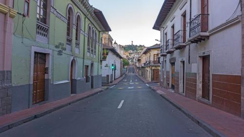 an empty street in a city with buildings at Hotel La Basílica Quito in Quito