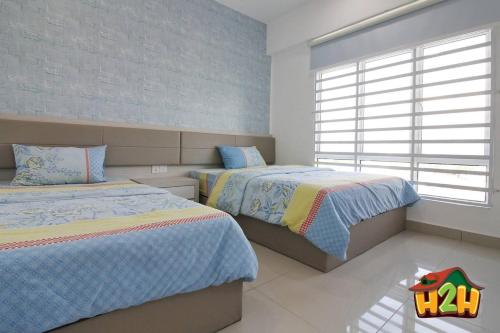 a bedroom with two beds and a window at H2H - Eleven14 Majestic Ipoh in Ipoh