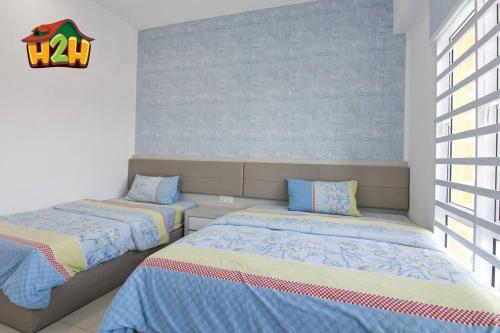 a bedroom with two beds and a window at H2H - Eleven14 Majestic Ipoh in Ipoh