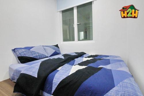 a bedroom with a bed and a window at H2H - Eleven14 Majestic Ipoh in Ipoh