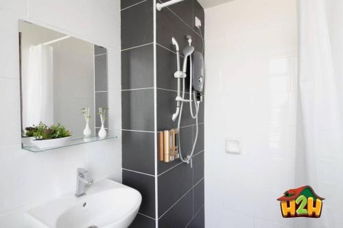 a bathroom with a sink and a mirror at H2H - Eleven14 Majestic Ipoh in Ipoh