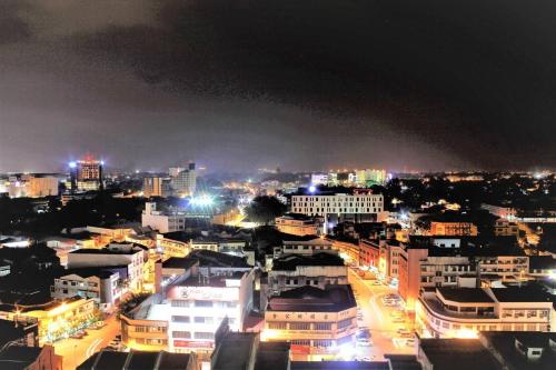 a city lit up at night with buildings at H2H - Eleven14 Majestic Ipoh in Ipoh