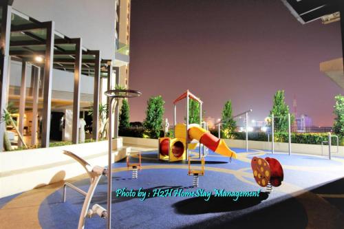 a playground with a slide in a building at H2H - Eleven14 Majestic Ipoh in Ipoh