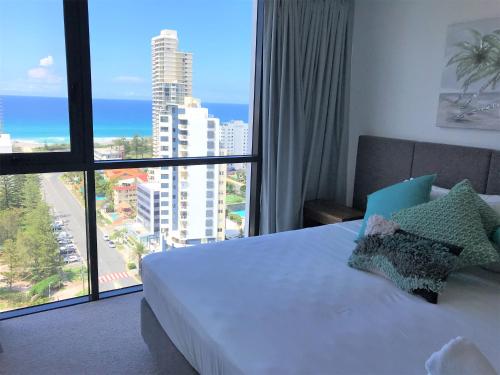 Qube Broadbeach Ocean View Apartments tesisinde bir odada yatak veya yataklar