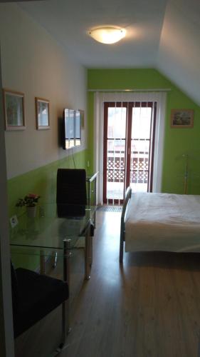 a hotel room with a bed and a glass table at Apartments U Kašny in Kadaň