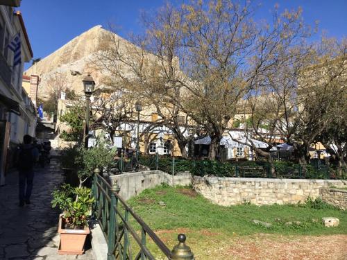 a person walking down a street next to a fence at Athens-Plaka, Peter’s beautiful apartment in Temple of Zeus in Athens