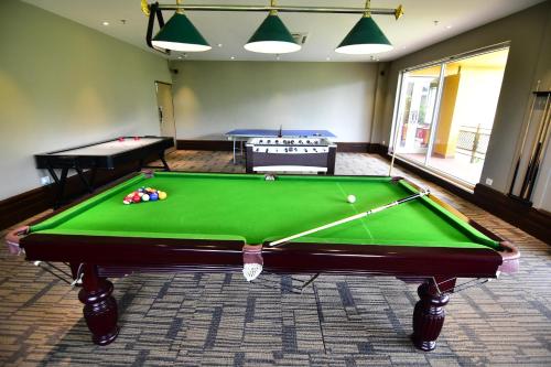 a room with a pool table and two tables at Swosti Chilika Resort in Kānāipur
