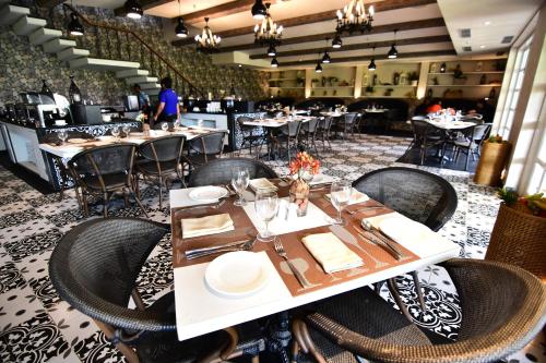 a dining room with tables and chairs in a restaurant at Swosti Chilika Resort in Kānāipur