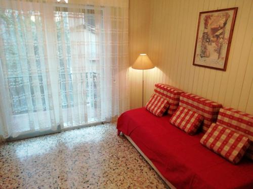 a bedroom with a red bed and a window at Via Funicolare in Brunate