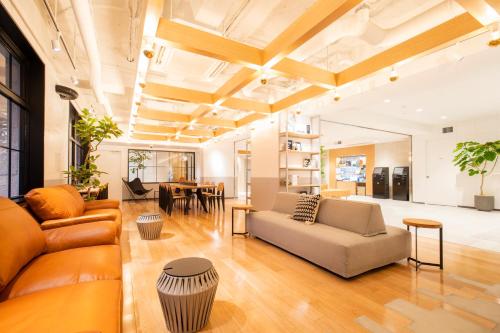 a living room with a couch and a table at Fukuoka Toei Hotel in Fukuoka