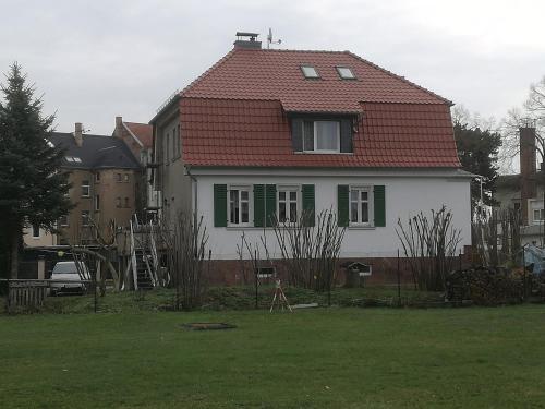 a large white house with a red roof at Auestraße 94A in Glauchau