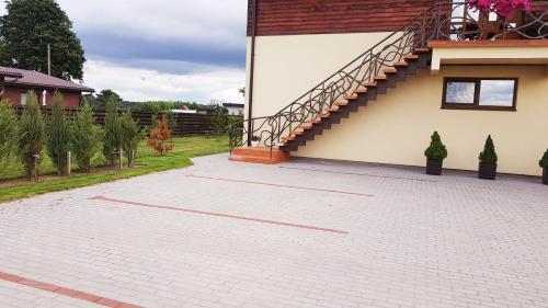 a brick patio with a staircase on the side of a house at Irmos Apartamentai salia Klaipedos in Toleikiai