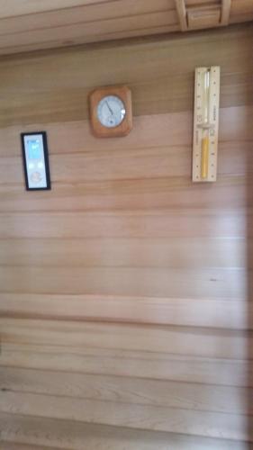a wall with a clock on a wooden wall at Hotel Fondovalle in Città della Pieve