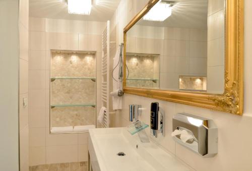 a bathroom with a sink and a mirror at Hotel Zehnthof in Cochem
