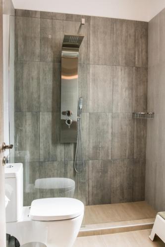 a bathroom with a shower with a toilet in it at Kampaki Stone Houses in Agios Nikitas