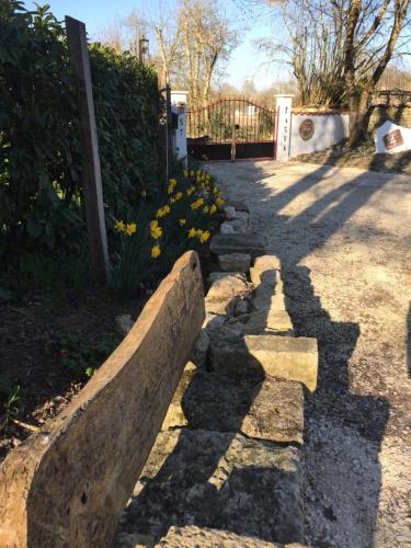 a walkway with rocks and flowers in a yard at St Pasha in Paillé