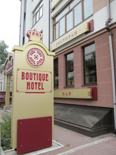 a sign for a boutique hotel in front of a building at Fontush Boutique Hotel in Ivano-Frankivsʼk