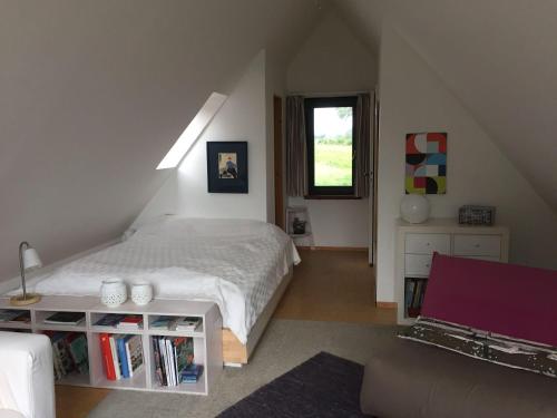 a bedroom with a bed and a table and a window at drunter-drueber-Maisonette-Ferienwohnung-Luebecker-Bucht in Scharbeutz