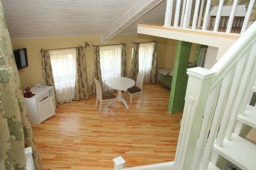 a room with a table and chairs and a staircase at Fontush Boutique Hotel in Ivano-Frankivsʼk