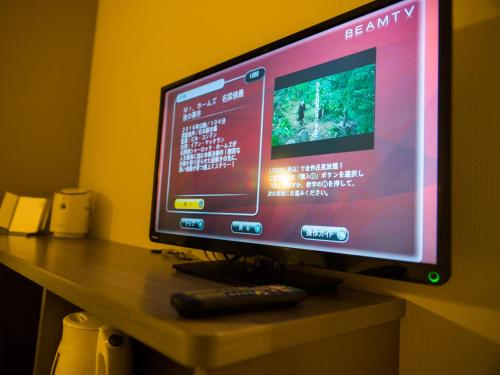 a computer monitor on a desk with a remote control at Super Hotel Tokyo Nihombashi Mitsukoshimae in Tokyo