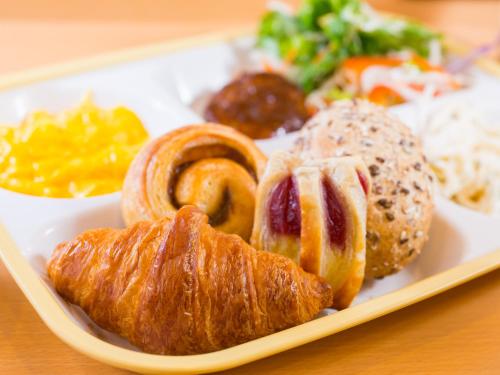 a plate of pastries and other foods on a table at Super Hotel Tokyo Nihombashi Mitsukoshimae in Tokyo