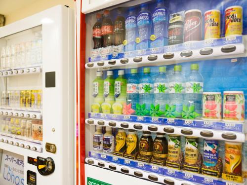 a refrigerator filled with bottles of soda at Super Hotel Tokyo Nihombashi Mitsukoshimae in Tokyo