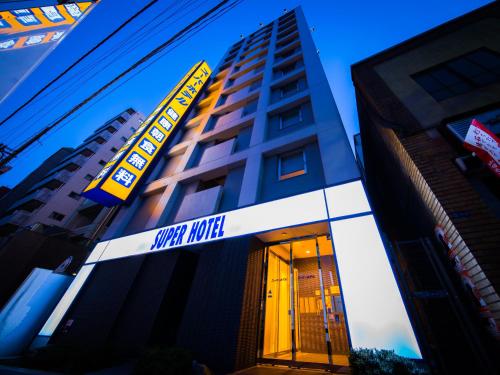 a building with a sign for a hotel at Super Hotel Tokyo Nihombashi Mitsukoshimae in Tokyo