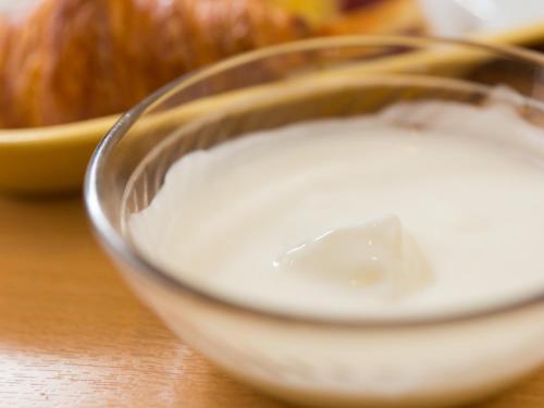 a bowl of milk on a table with an apple at Super Hotel Tokyo Nihombashi Mitsukoshimae in Tokyo