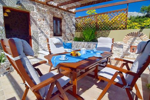 a wooden table and chairs on a patio at Sevi's Traditional House in Kalymnos
