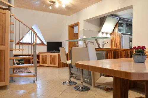a kitchen and dining room with a table and chairs at Apartments Povh in Ljubno