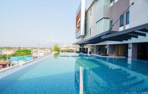 a large swimming pool next to a building at Best Western Plus Metro Clark in Angeles