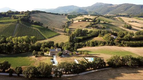 an aerial view of a farm with mountains in the background at Da Foschetta in Matelica