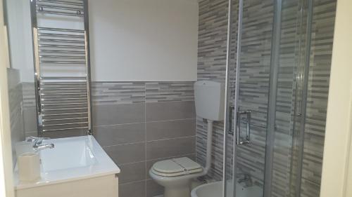 a bathroom with a toilet and a sink at B&B Villa Letizia in Castelbuono