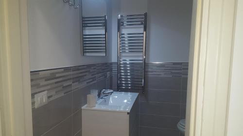 a bathroom with a sink and a toilet at B&B Villa Letizia in Castelbuono