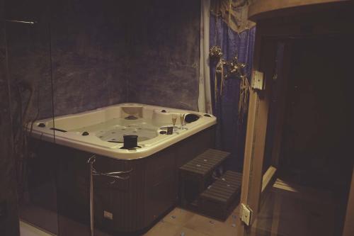 a bathroom with a bath tub in a room at Residenza Mordini in La Maddalena