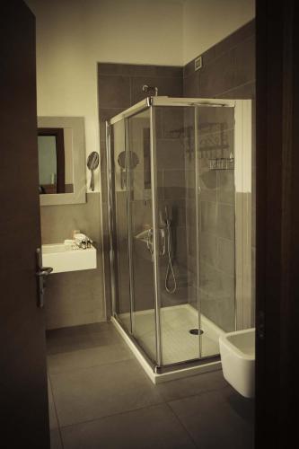 a bathroom with a shower with a sink and a toilet at Residenza Mordini in La Maddalena