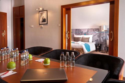 a conference room with a table with a laptop on it at Hotel Hanza in Gdańsk