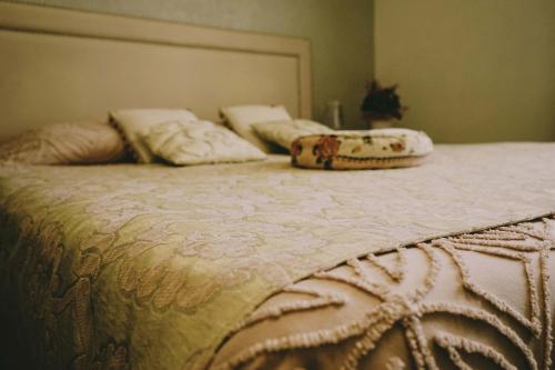 a bed with two pillows on top of it at Residenza Mordini in La Maddalena