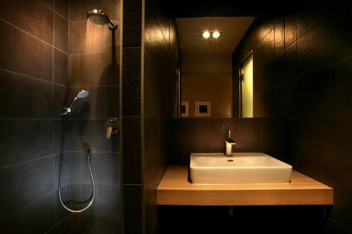 a bathroom with a sink and a shower and a mirror at Gateway Budapest City Center in Budapest