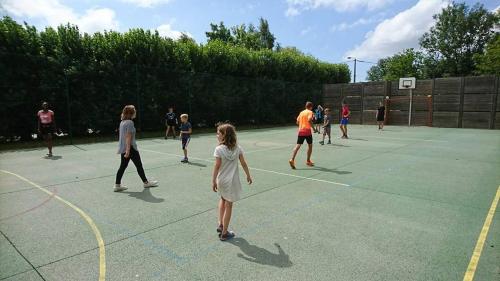 a group of people playing basketball on a court at Camping la Haie Penée **** in Saint-Quentin-en-Tourmont