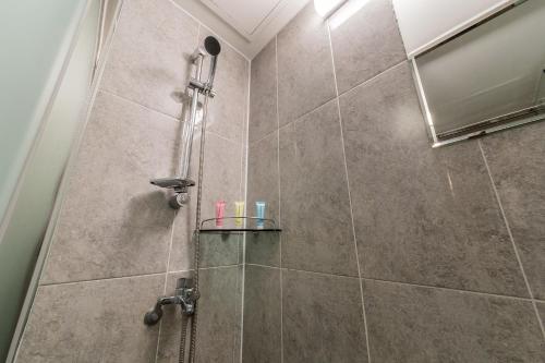 a bathroom with a shower with a glass door at Pyeongtaek Stay Tourist Hotel in Pyeongtaek