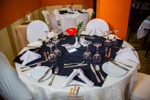 a table with plates and silverware on top of it at Utalii Hotel in Nairobi