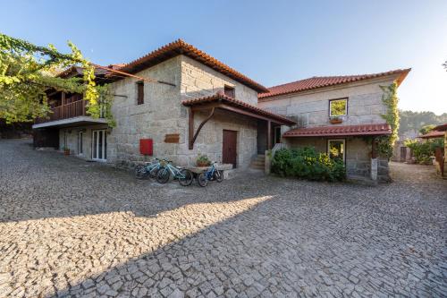 a house with bikes parked in front of it at Quinta da Pousadela - Agroturismo in Amarante
