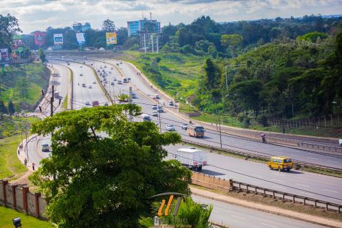 a highway with cars and trucks on the road at Utalii Hotel in Nairobi