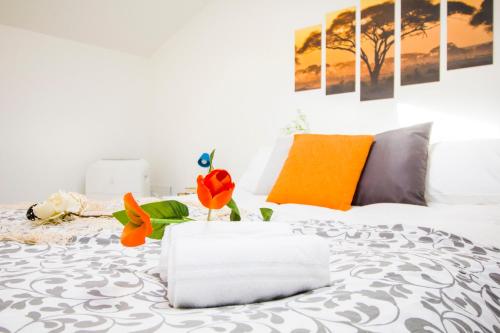 a bedroom with a white bed with flowers on it at InnPisaRentals 2 - Airstation Central Flat in Pisa