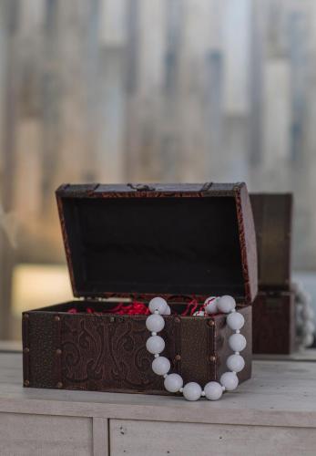 a wooden box with white beads on top of it at Ble on Blue in Athanion