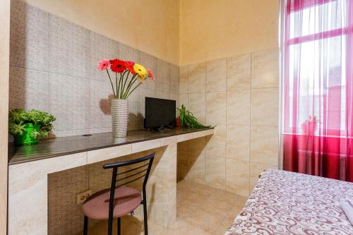 a room with a counter with a vase with flowers at Dream Apartments in Kyiv