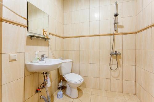 a bathroom with a toilet and a sink and a shower at Dream Apartments in Kyiv