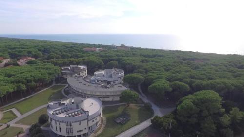 an aerial view of a building in the middle of a forest at CSA Hotel Beach & Park in Marina di Bibbona
