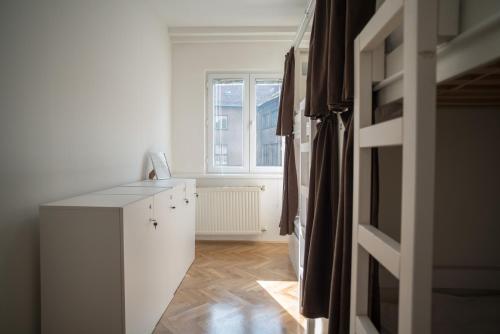 a room with a white cabinet and a window at The Good Place Hostel in Sarajevo